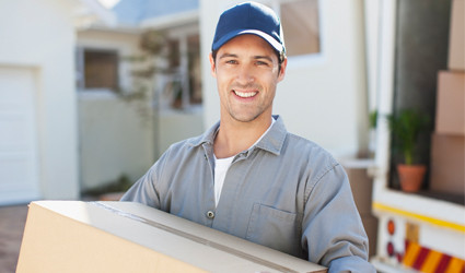 Moving Support Services mover carrying a box